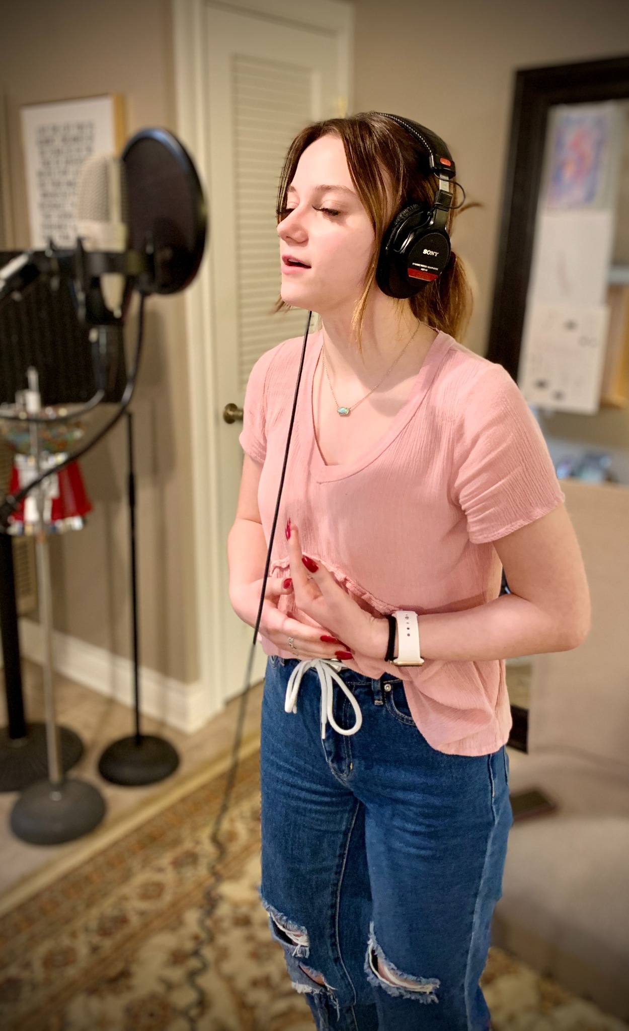 A teenage student singing in the recording studio
