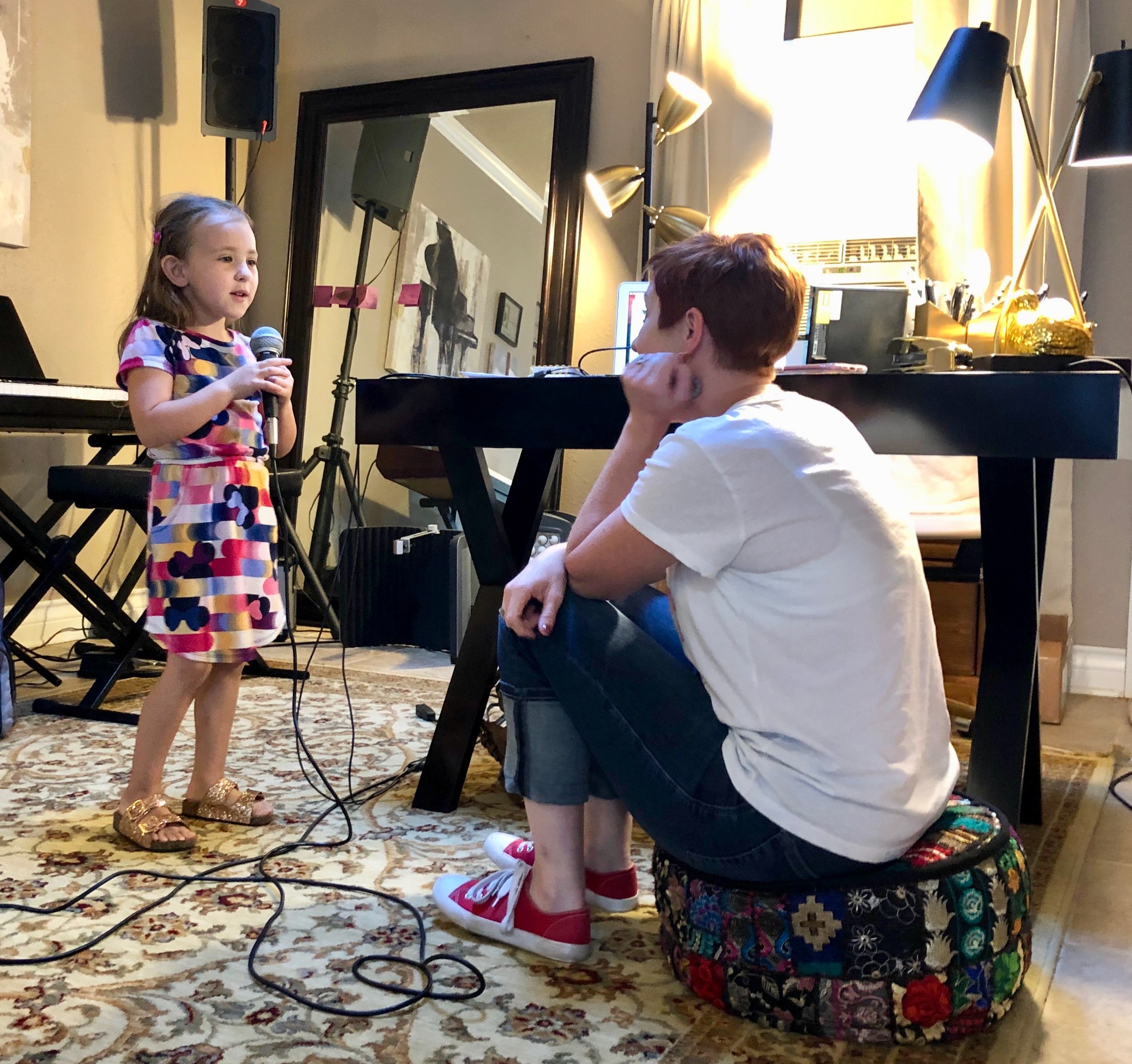 Amber listening closely as a young student sings during an individual voice lesson
